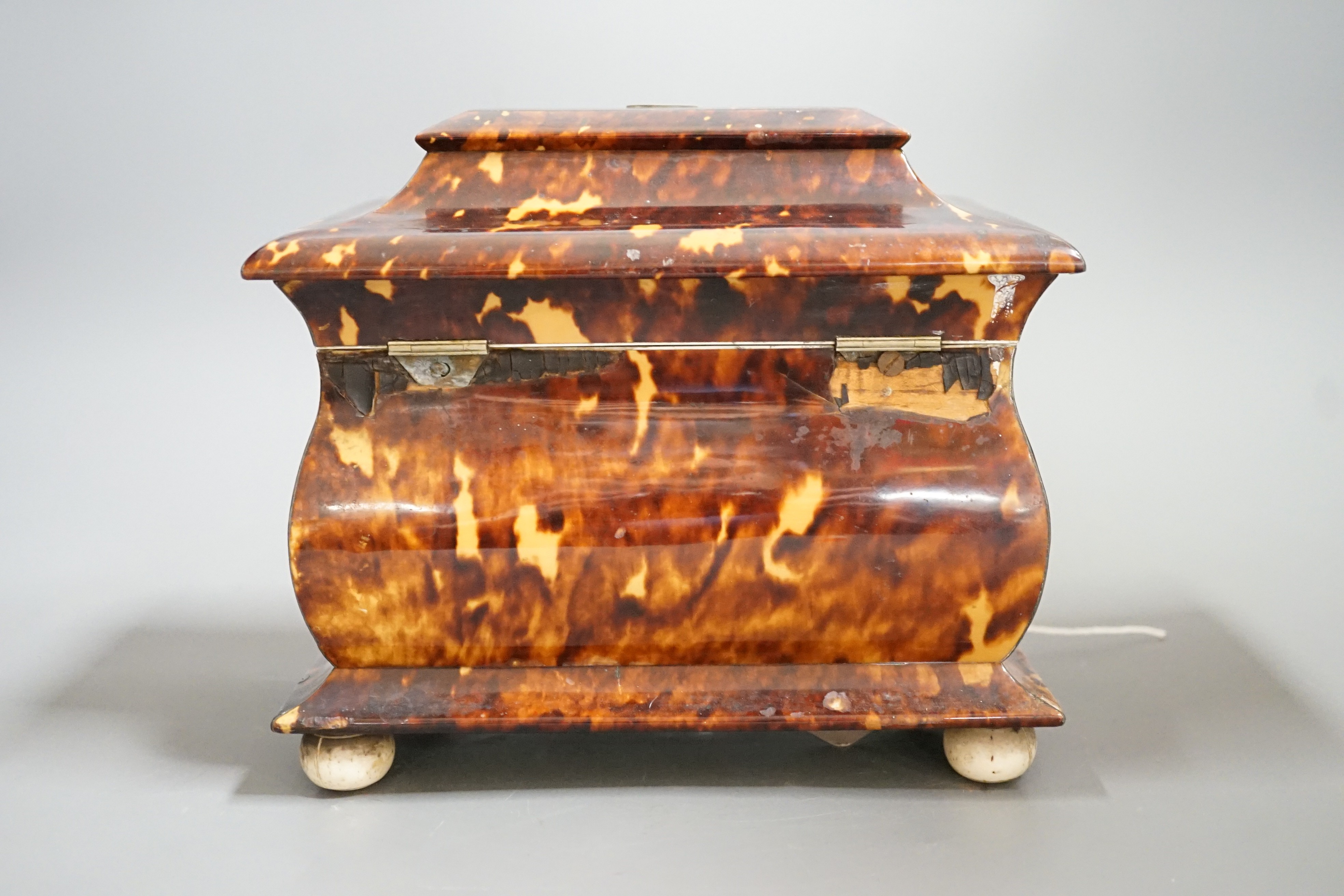 A Victorian tortoiseshell and ivory mounted tea caddy, 18cms high